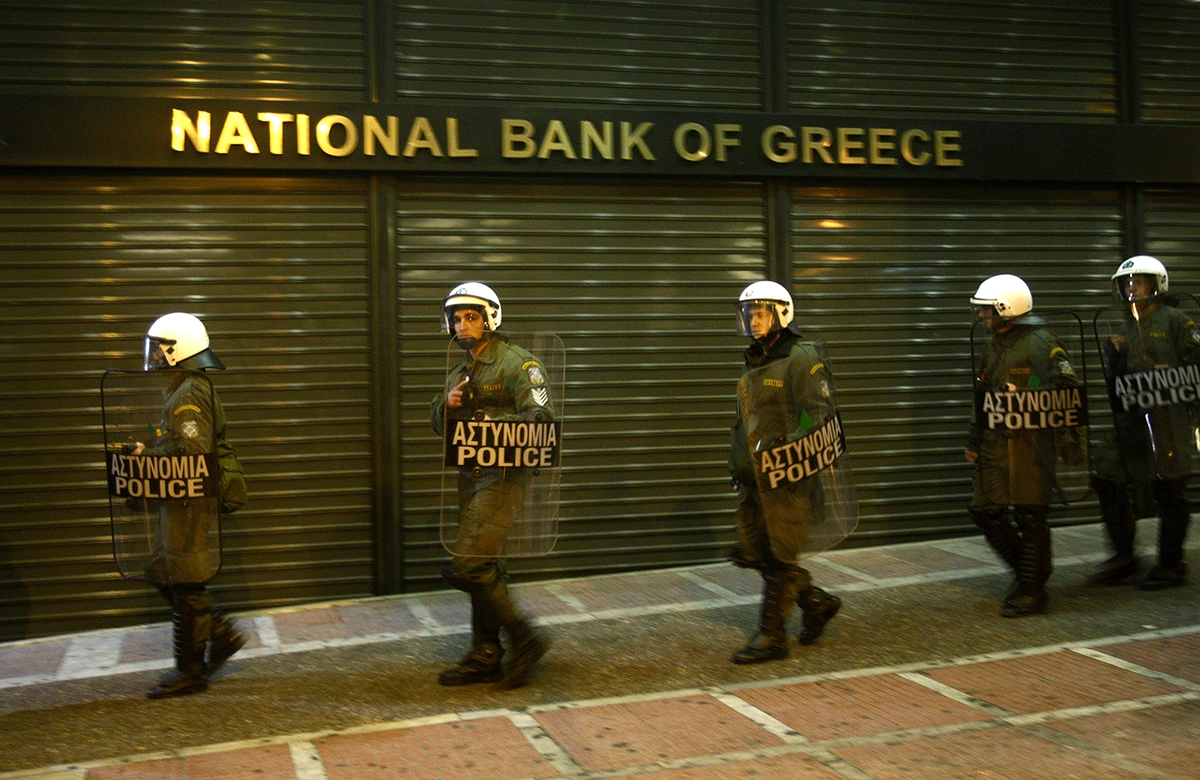 Riot Police in Front of a Branch of the National Bank of Greece, REUTERS/John Kolesidis 